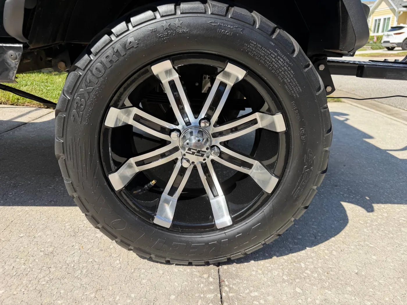 14-inch machined black alloy wheel on a street tire