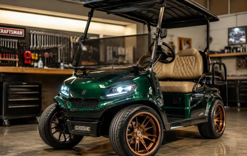 Green custom golf cart with bronze wheels in a shop